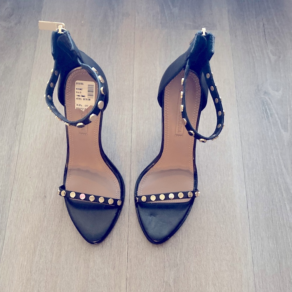 Black BCBG strapped open toes pumps.
